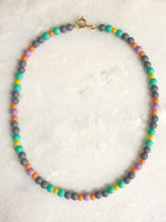 "Necklace Grey surrounded by colours"